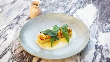 A dessert on a plate with a marble background.