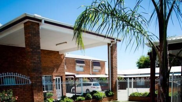 A swimming pool with a tiled edge and a hot tub in the center.