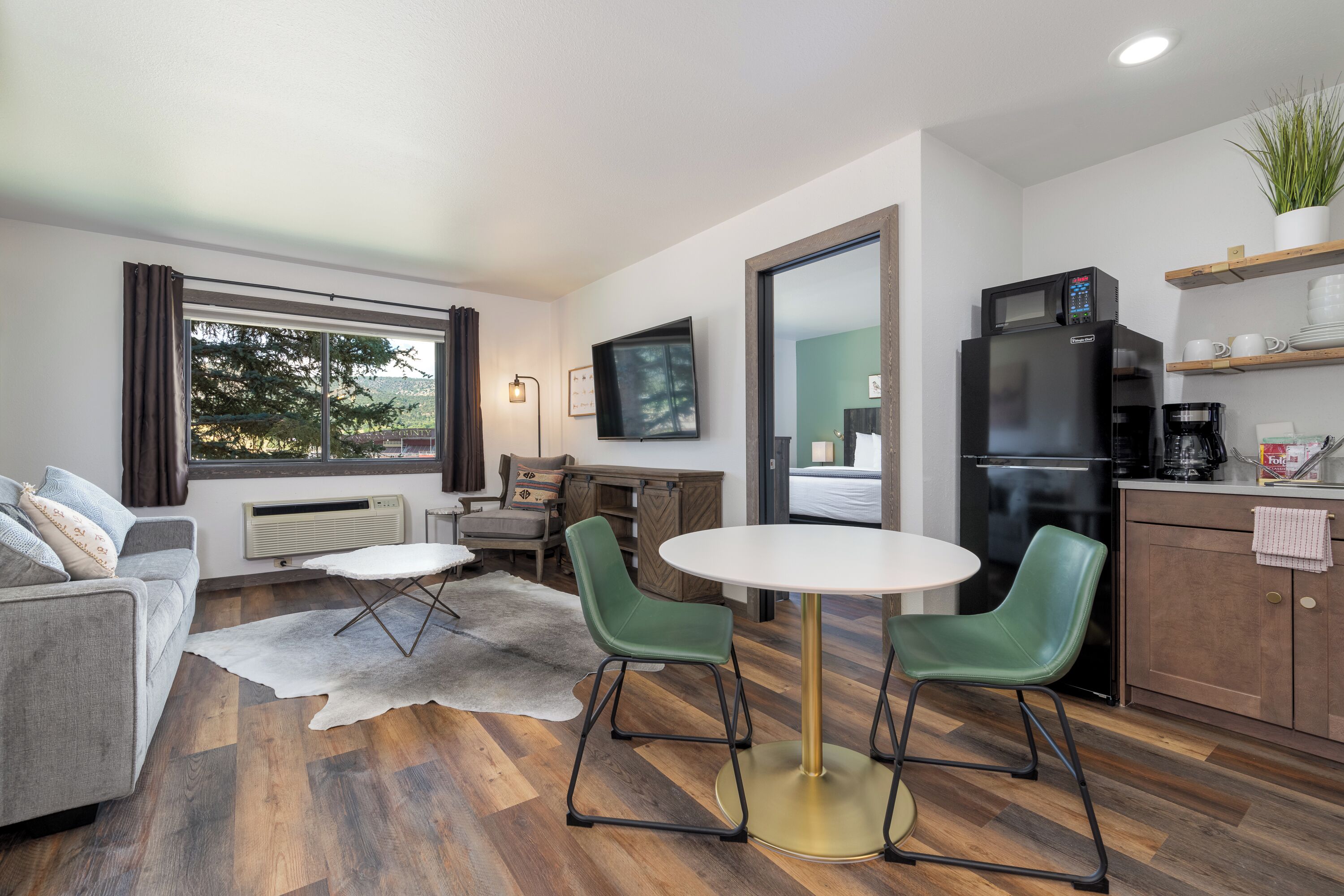 deluxe suite, 1 king bed with sofa bed, kitchenette, mountain view | living area | 50-inch smart tv with cable channels, tv