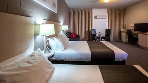 A hotel room with two beds, a desk, a chair, and a television. - Comfort Inn & Suites King Avenue (Sale)