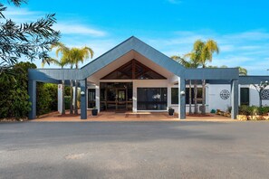 A modern building with a triangular roof, large glass entrance, and a paved driveway. - Comfort Inn & Suites Riverland (Barmera)