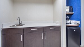 A kitchen with a sink, cabinets, a microwave, and a refrigerator. - Holiday Inn Express Hotel & Suites Bishop by IHG (Bishop)