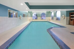 A large indoor swimming pool with clear blue water, surrounded by walls with windows and a ceiling with recessed lighting. - Holiday Inn Express Hotel & Suites Bishop by IHG (Bishop)