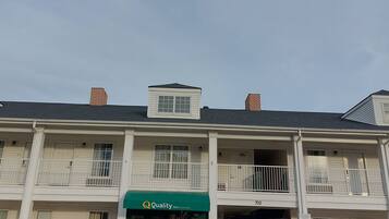 A two-story building with a green awning labeled "Quality Inn by Wyndham."