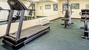 A gym with cardio equipment, weight machines, and mirrors. - Quality Inn Carrollton Medical Center (Carrollton)