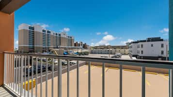 A parking area with a view of a hotel and other buildings.