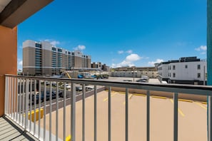 A parking area with a view of a hotel and other buildings.