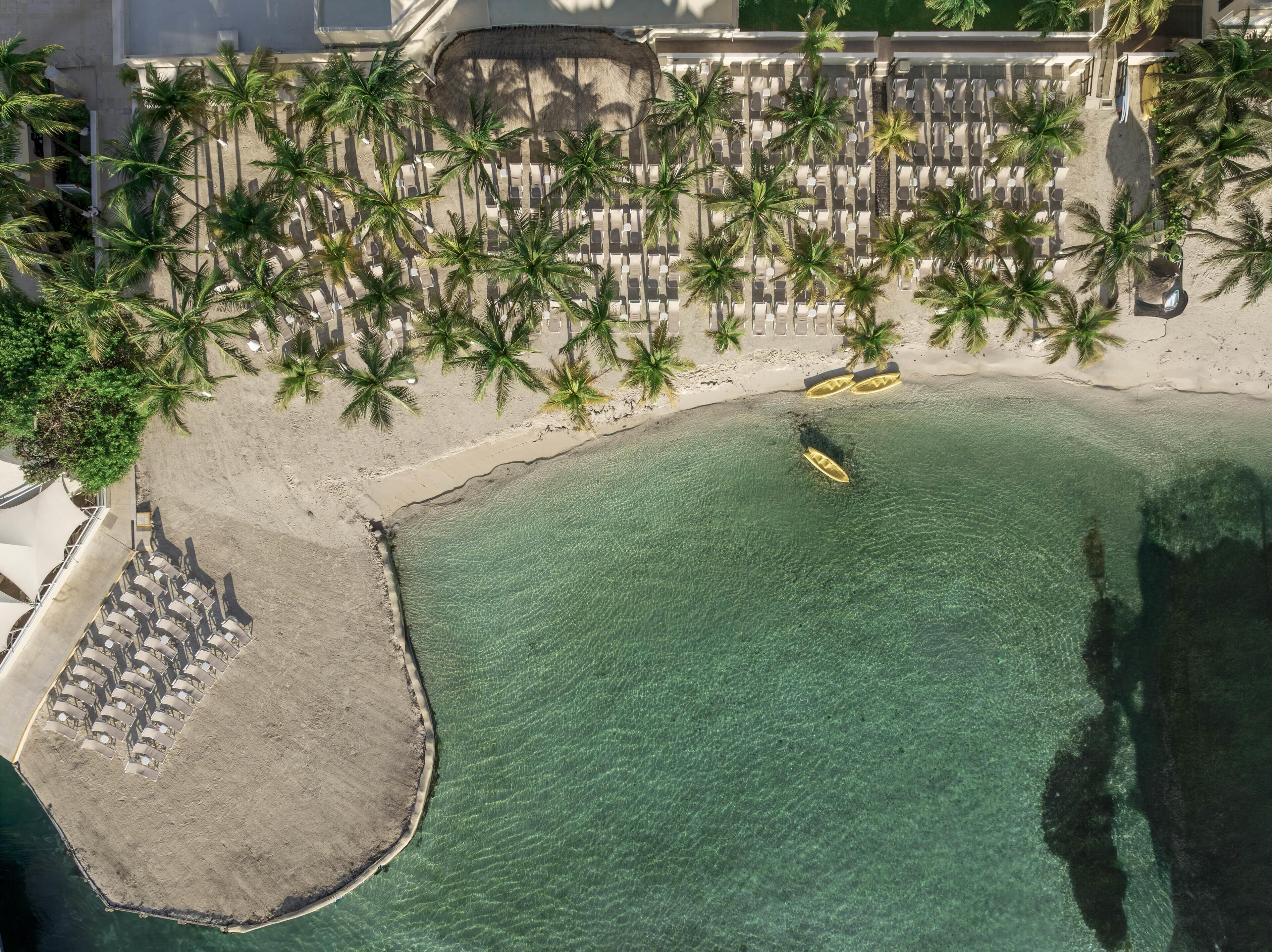 On the beach, white sand, sun loungers, beach umbrellas