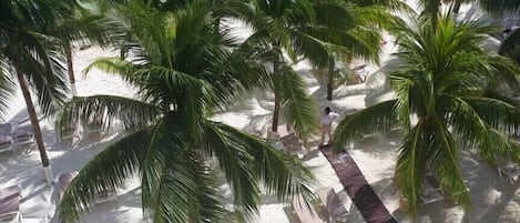 On the beach, white sand, sun-loungers, beach umbrellas