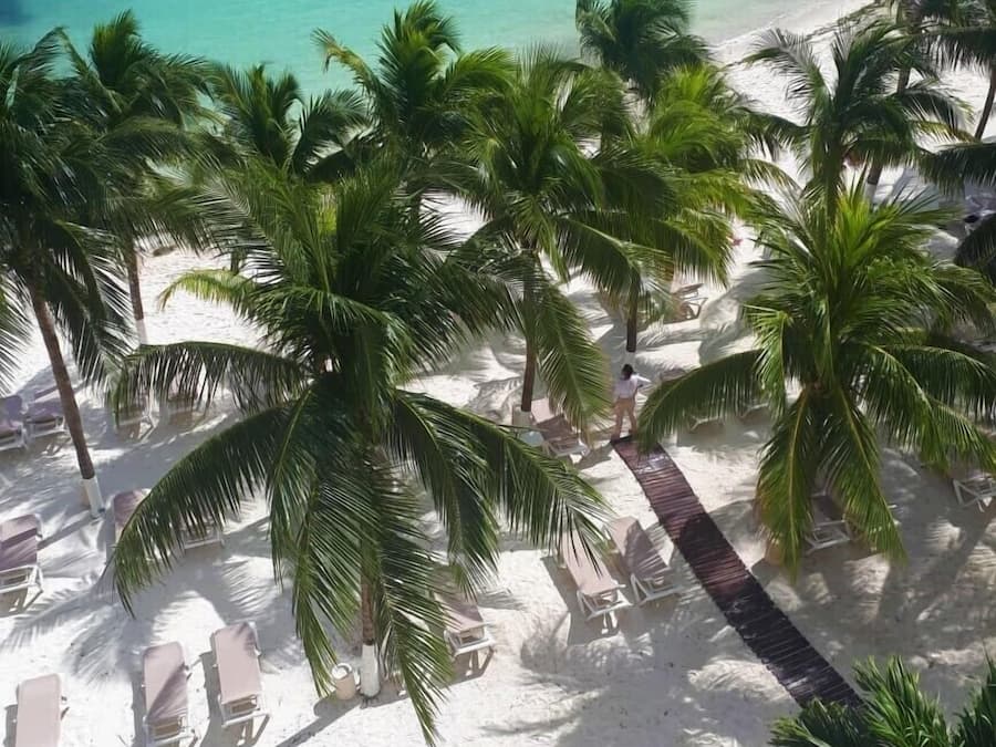 On the beach, white sand, sun-loungers, beach umbrellas