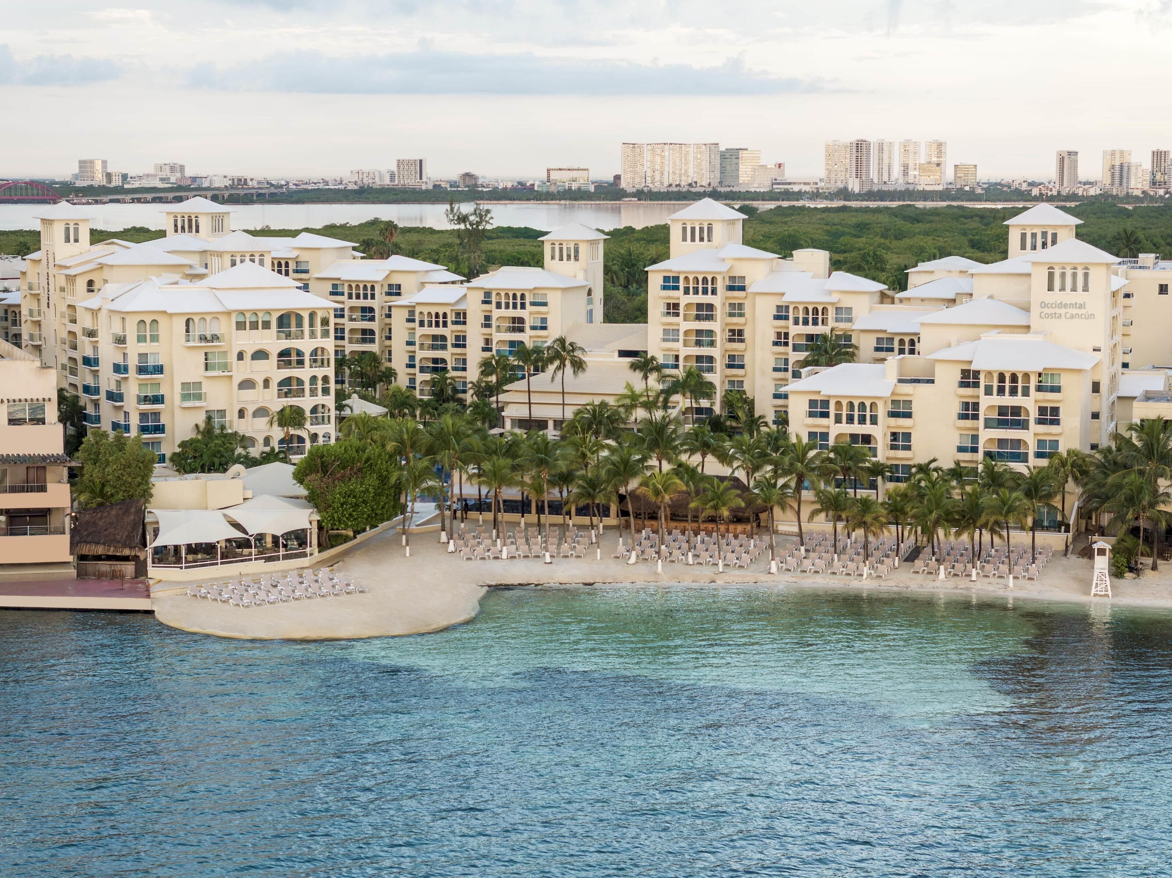 On the beach, white sand, sun loungers, beach umbrellas