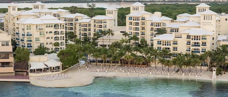On the beach, white sand, sun loungers, beach umbrellas