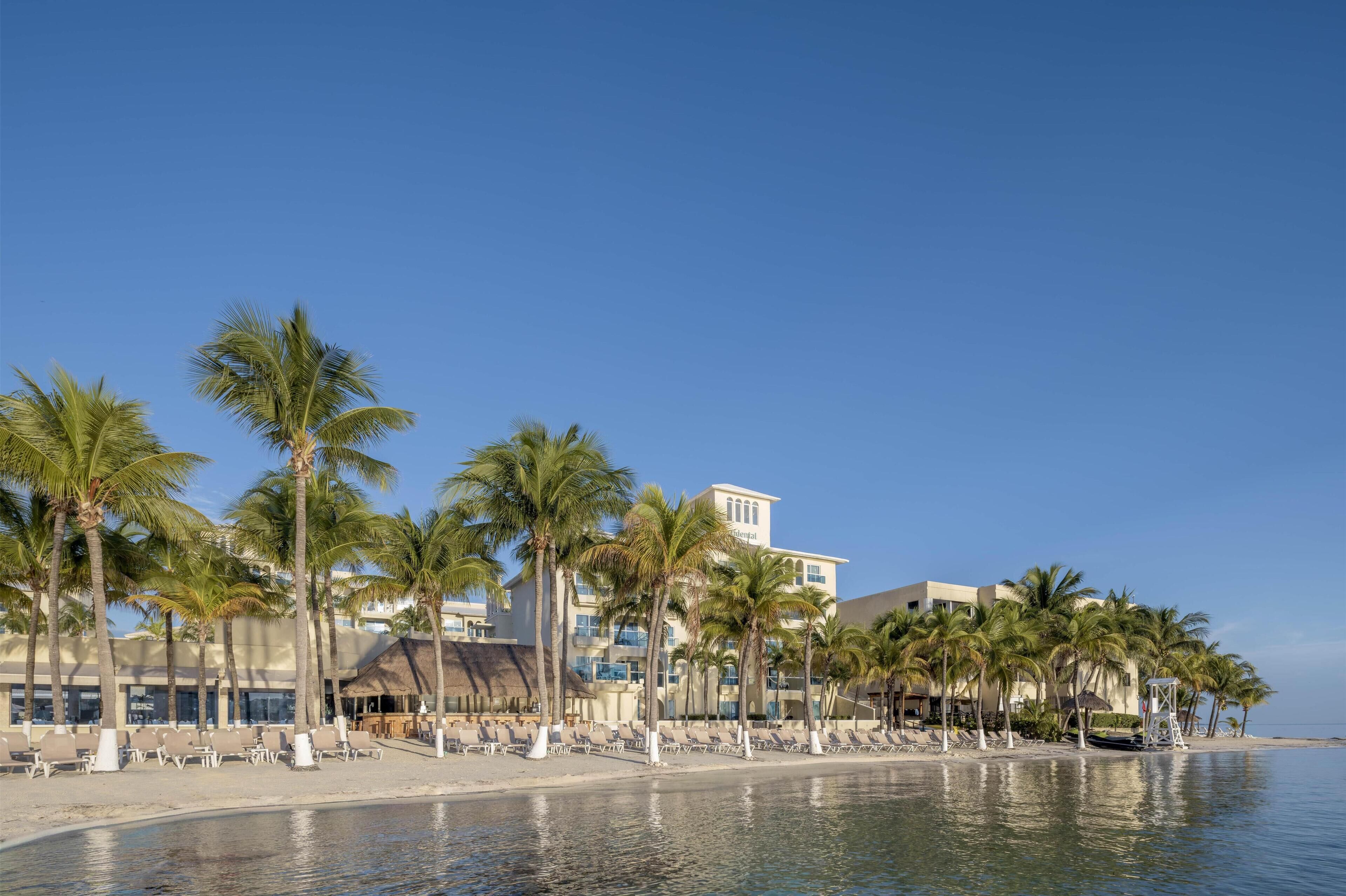 On the beach, white sand, sun loungers, beach umbrellas