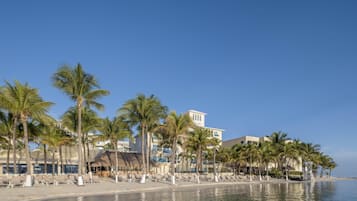 On the beach, white sand, sun loungers, beach umbrellas