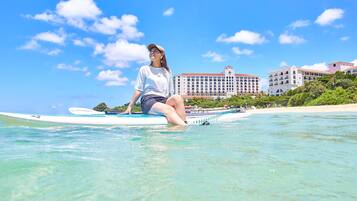 On the beach, white sand, beach umbrellas, beach towels