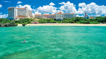 On the beach, white sand, beach umbrellas, beach towels