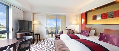 A hotel room with a large bed, a TV, a dining table, and a balcony with a view.