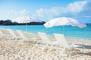 On the beach, white sand, beach umbrellas, beach towels