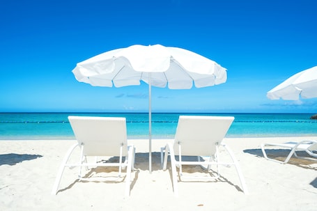 On the beach, white sand, beach umbrellas, beach towels