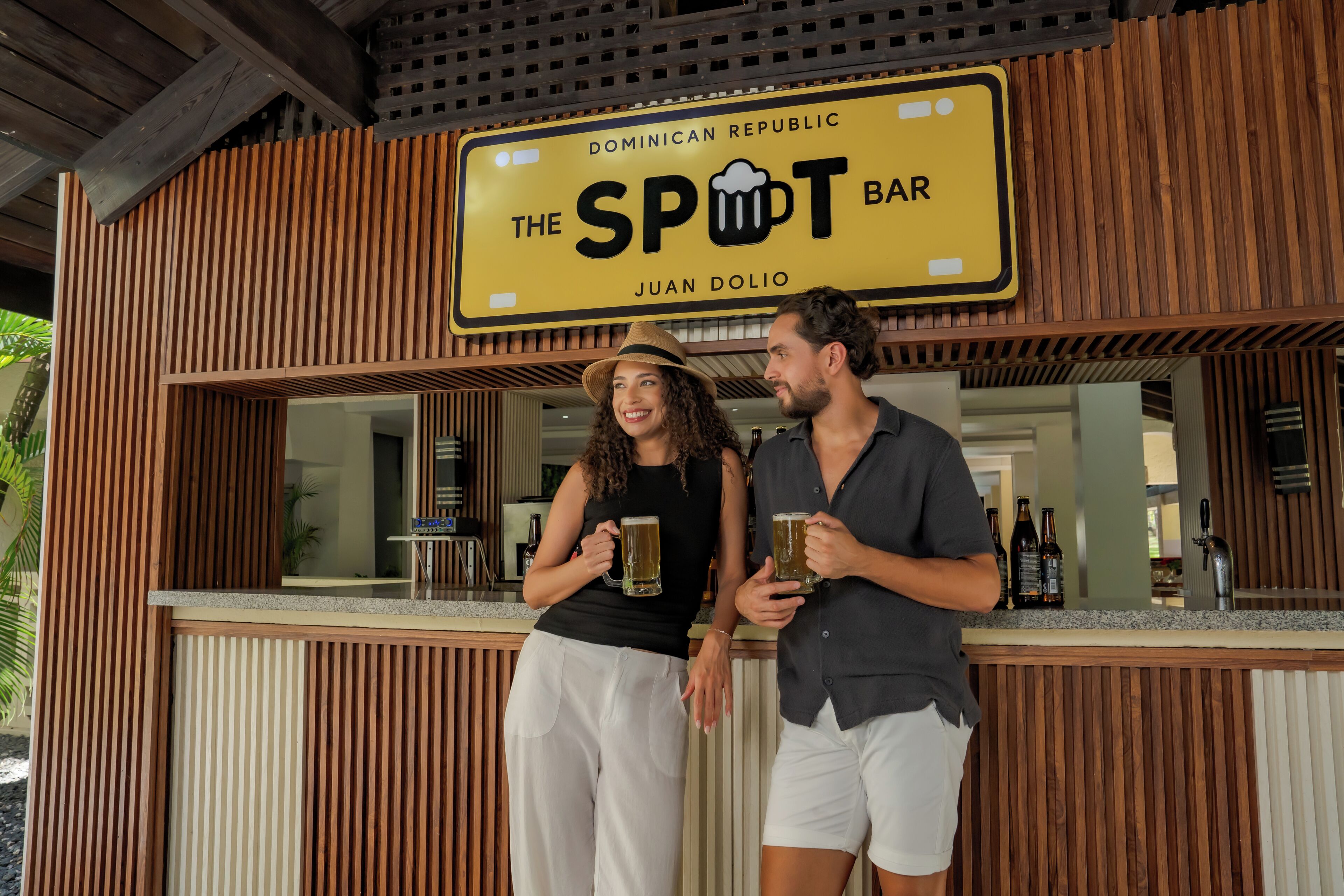A bar named "The Spot Bar" with a wooden exterior and a sign indicating it is in the Dominican Republic.