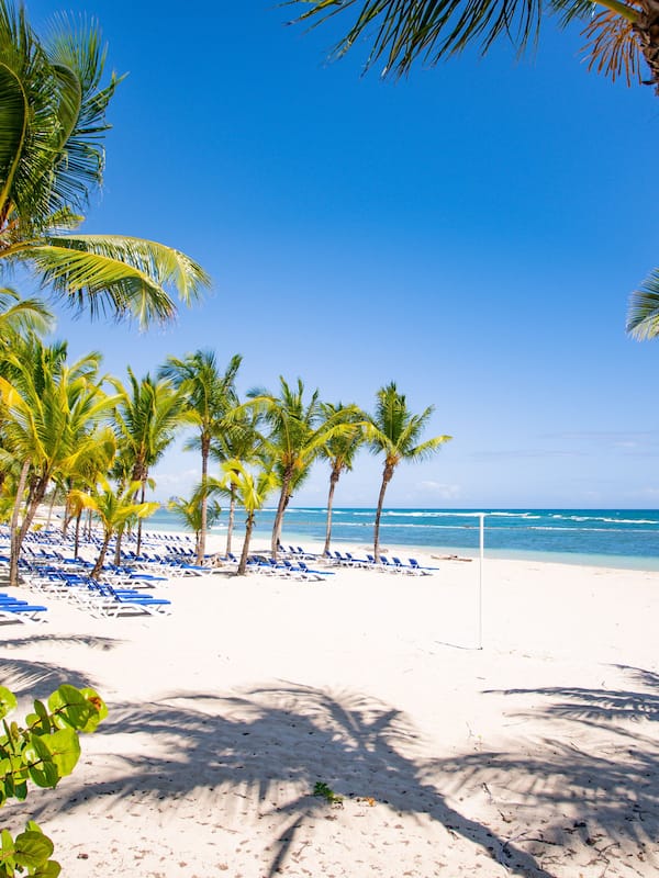 On the beach, white sand, sun loungers, beach umbrellas