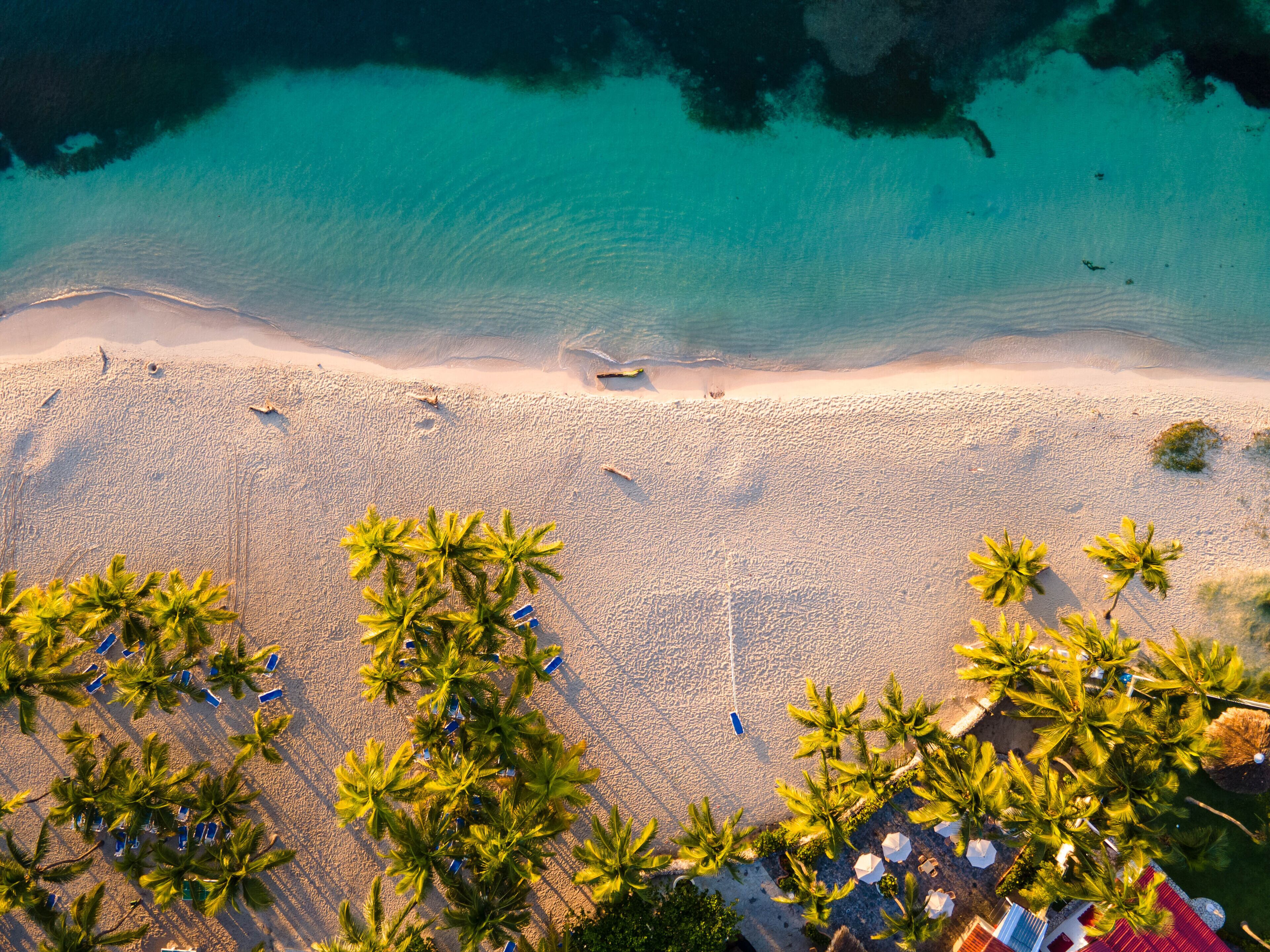 On the beach, white sand, sun-loungers, beach umbrellas