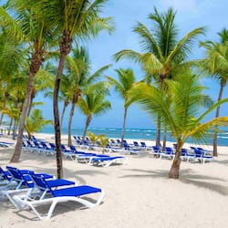 On the beach, white sand, sun loungers, beach umbrellas