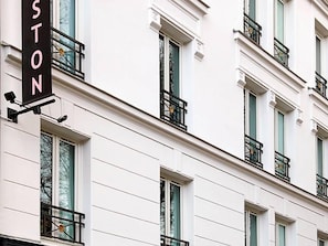 A multi-story building with a sign that reads 'STON' on the facade.