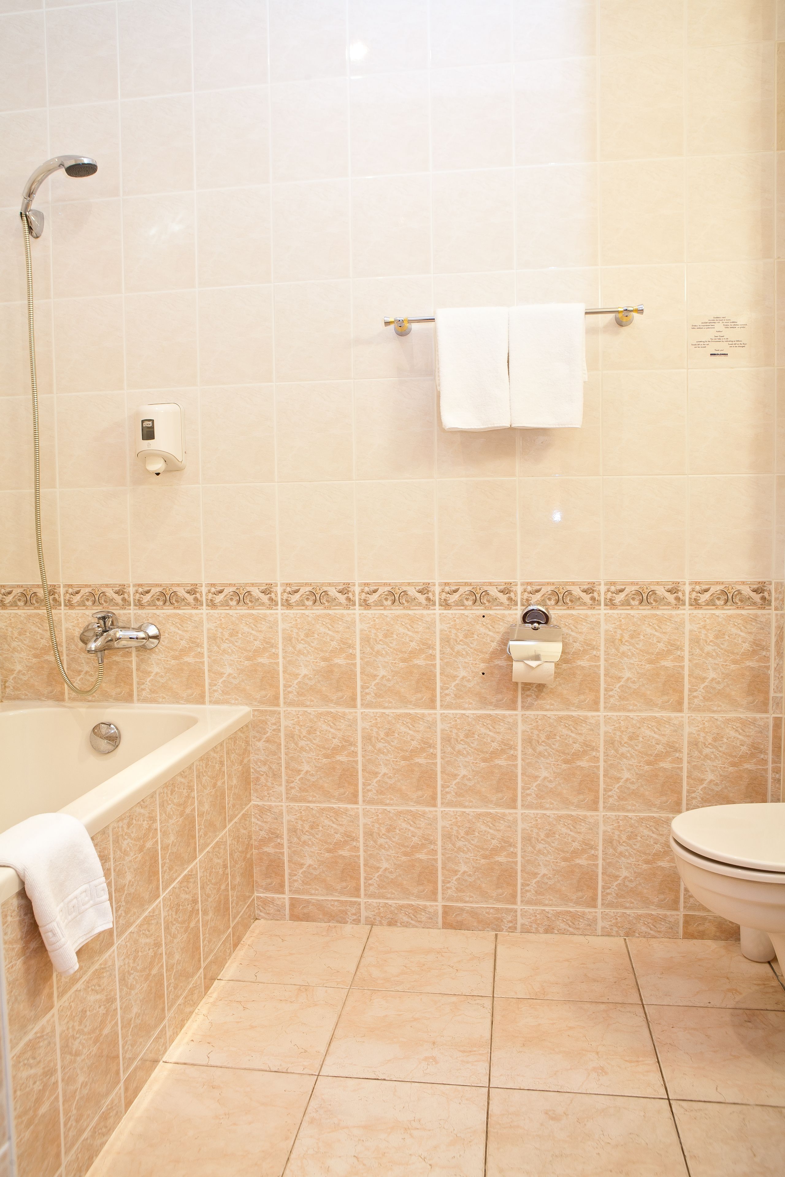 A bathroom with a bathtub, a toilet, and a shower.