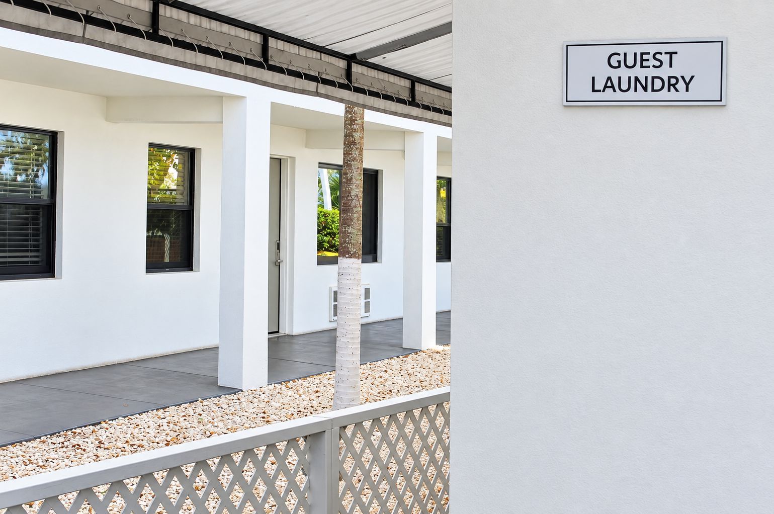 A building with a sign reading 'GUEST LAUNDRY' indicating a facility for guests.