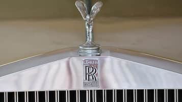 A close-up of a Rolls-Royce emblem on a vehicle's hood.