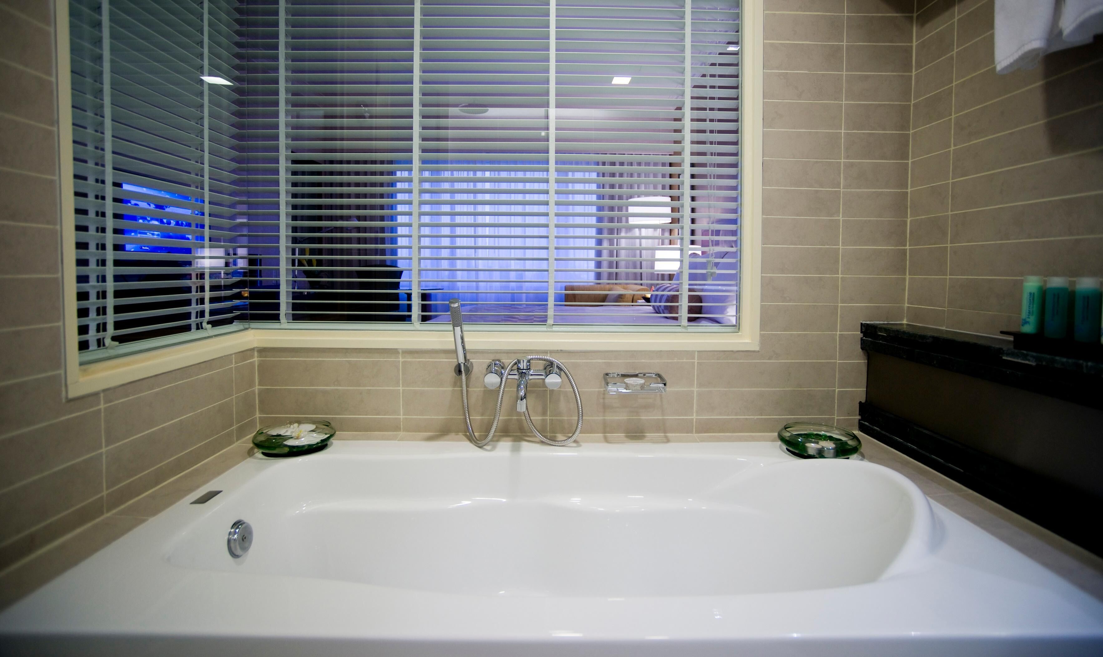 club deluxe room (1 king bed) | bathroom | eco-friendly toiletries, hair dryer, bathrobes, slippers