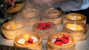 A variety of dim sum dishes in bamboo steamers, indicating a Chinese cuisine setting.