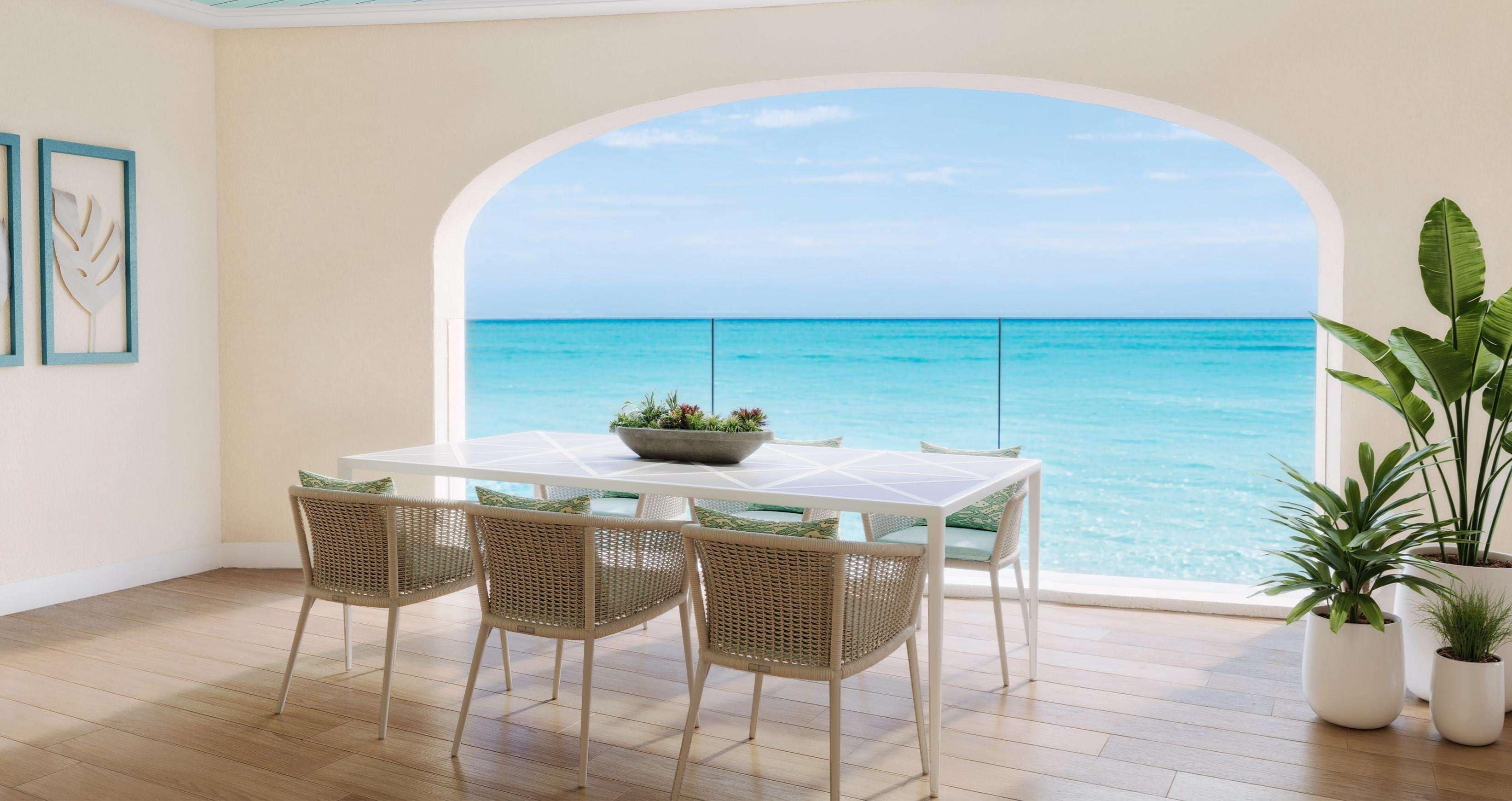 A dining area with a table and chairs, a view of the ocean, and potted plants.