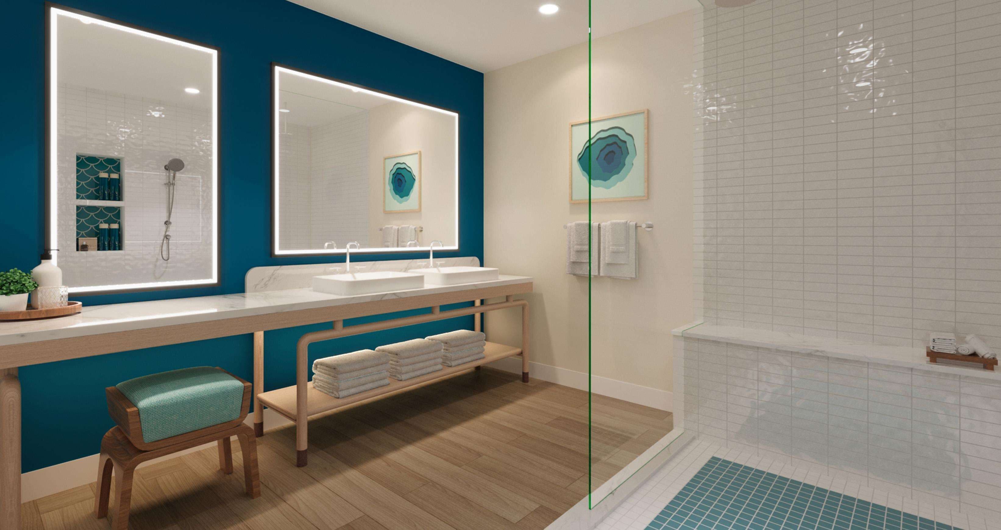A modern bathroom with two sinks, a shower, and a vanity with a mirror.