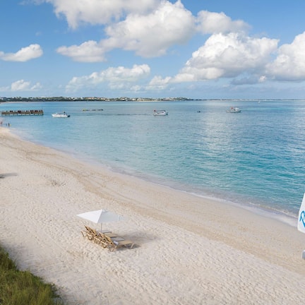 On the beach, white sand, sun loungers, beach umbrellas