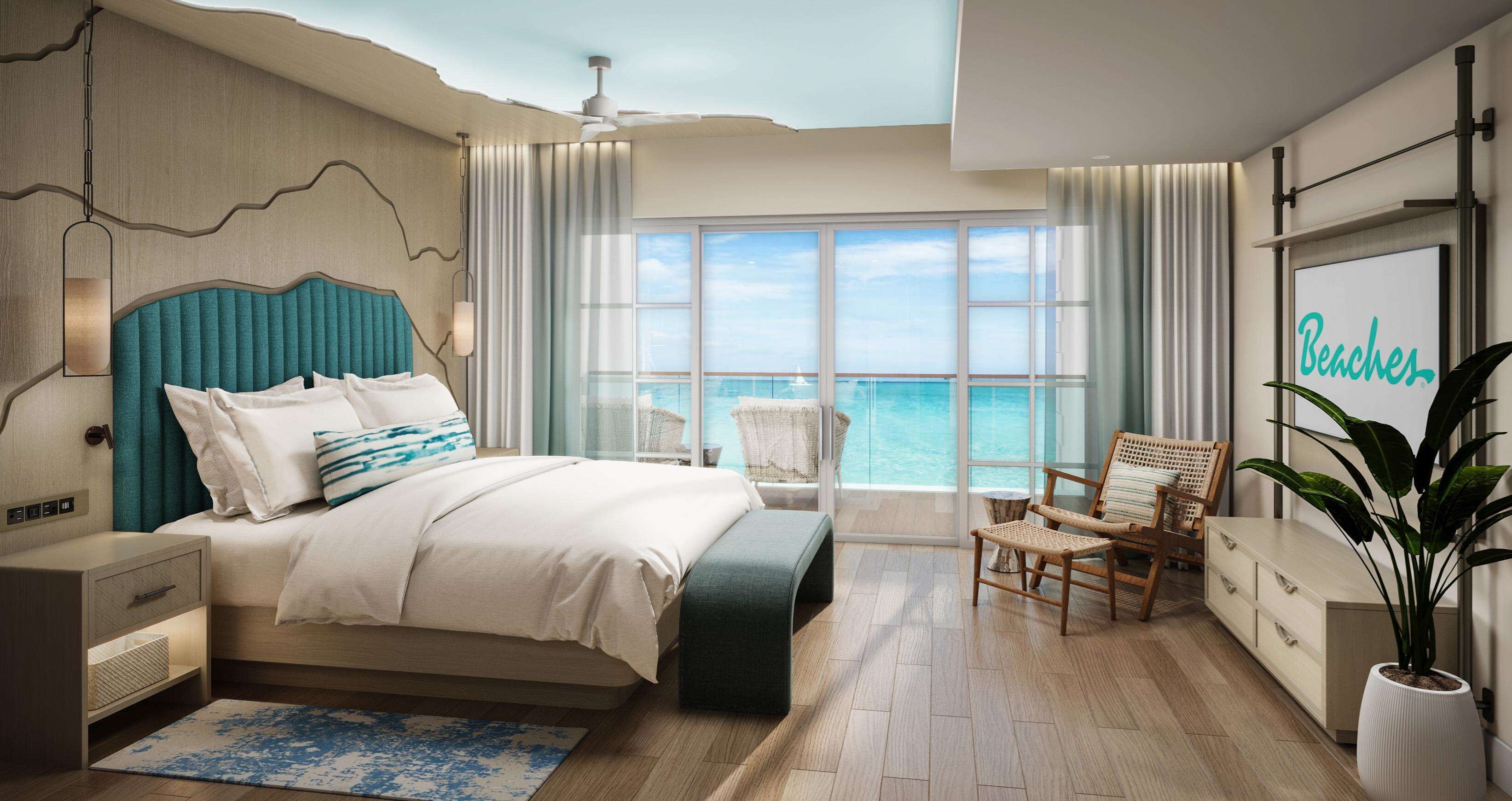 Een moderne slaapkamer met een groot bed, uitzicht op zee, een plafondventilator en een bordje 'Beaches' aan de muur.