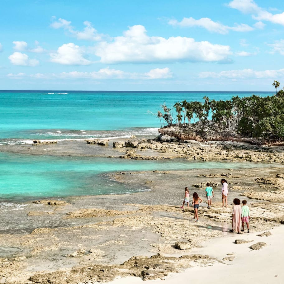 On the beach, white sand, sun loungers, beach umbrellas