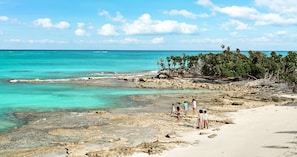 On the beach, white sand, sun-loungers, beach umbrellas