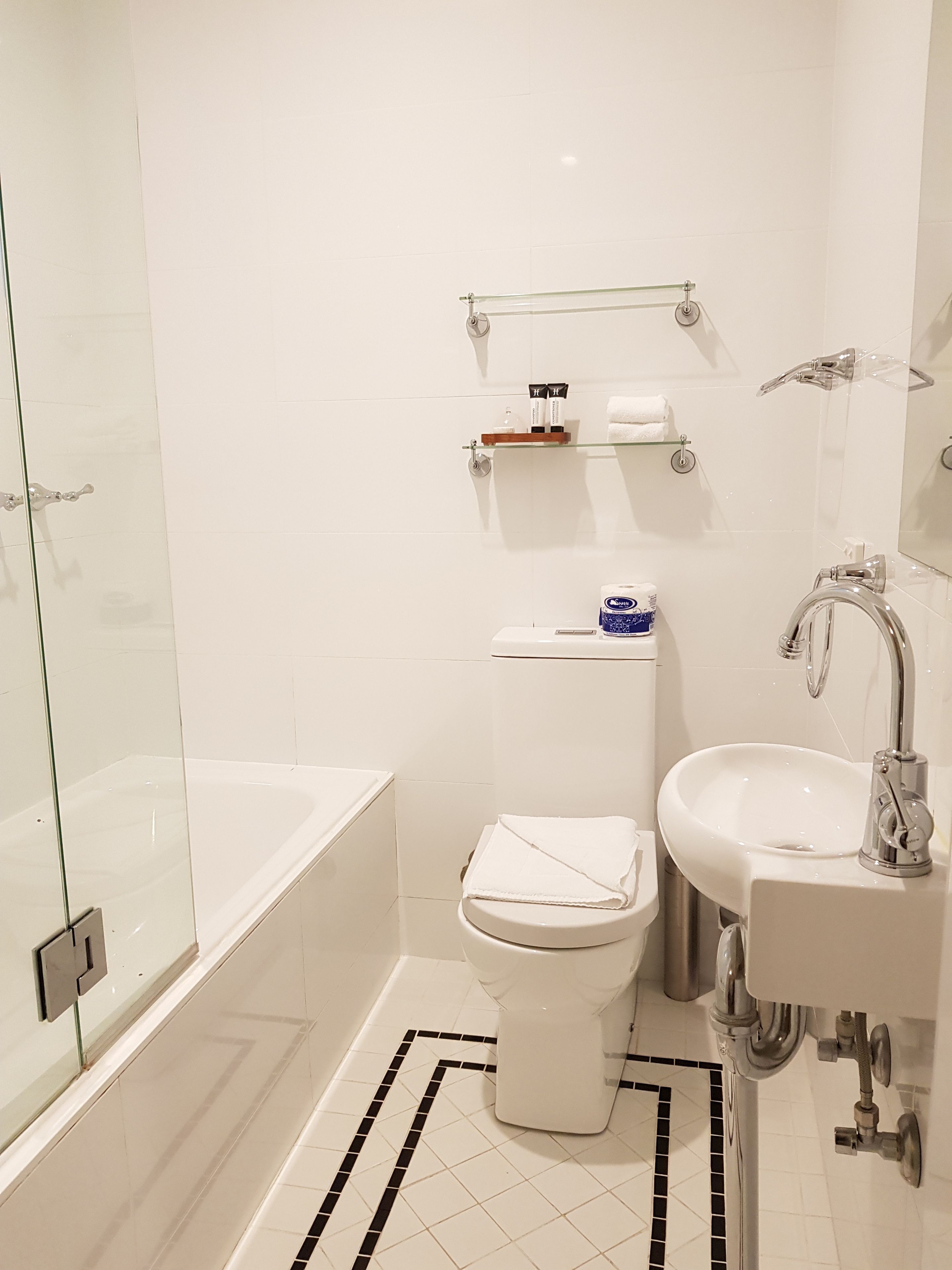 A modern bathroom with a bathtub, toilet, and sink.