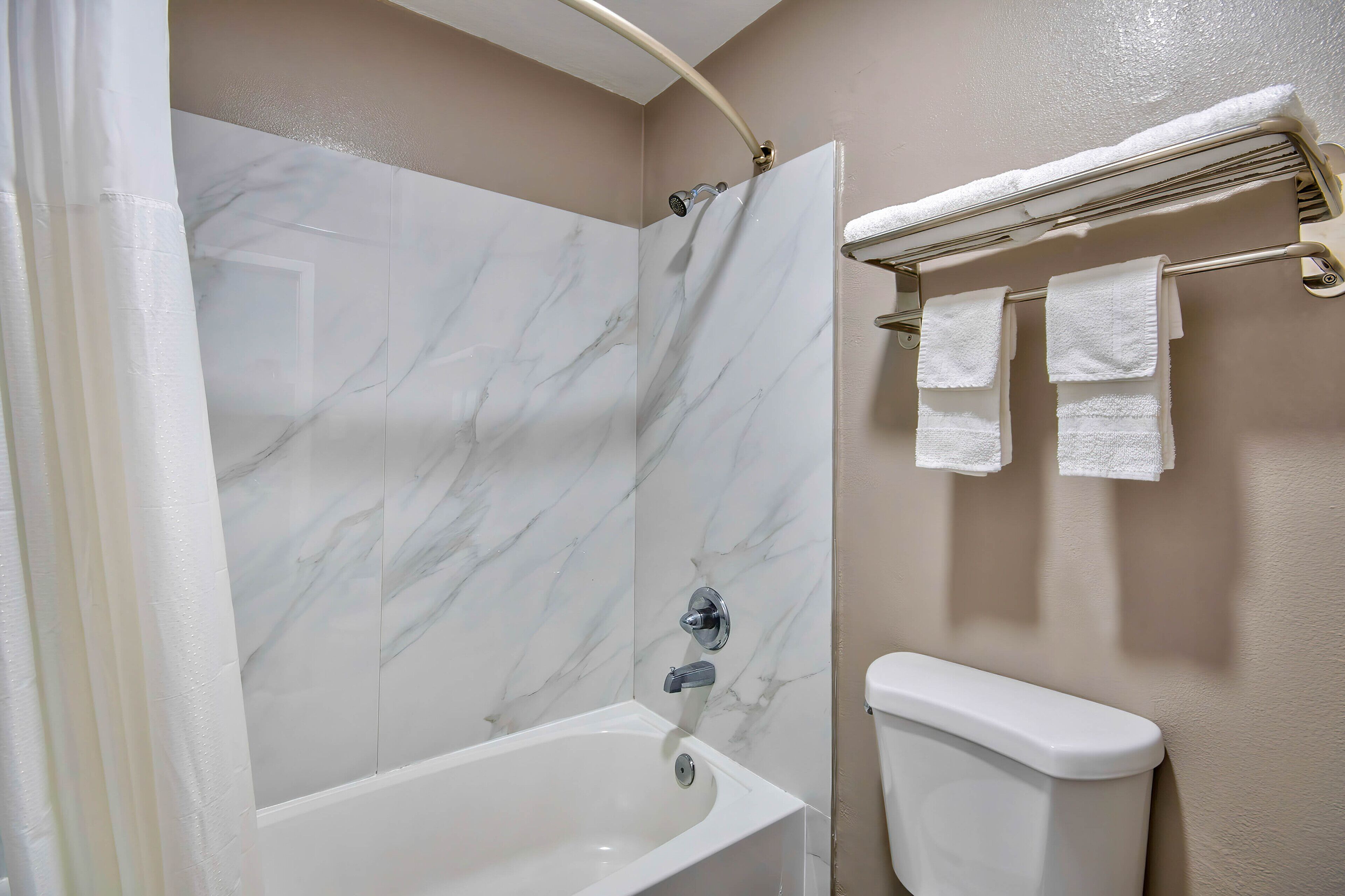 A bathroom with a bathtub, a shower, and a toilet.