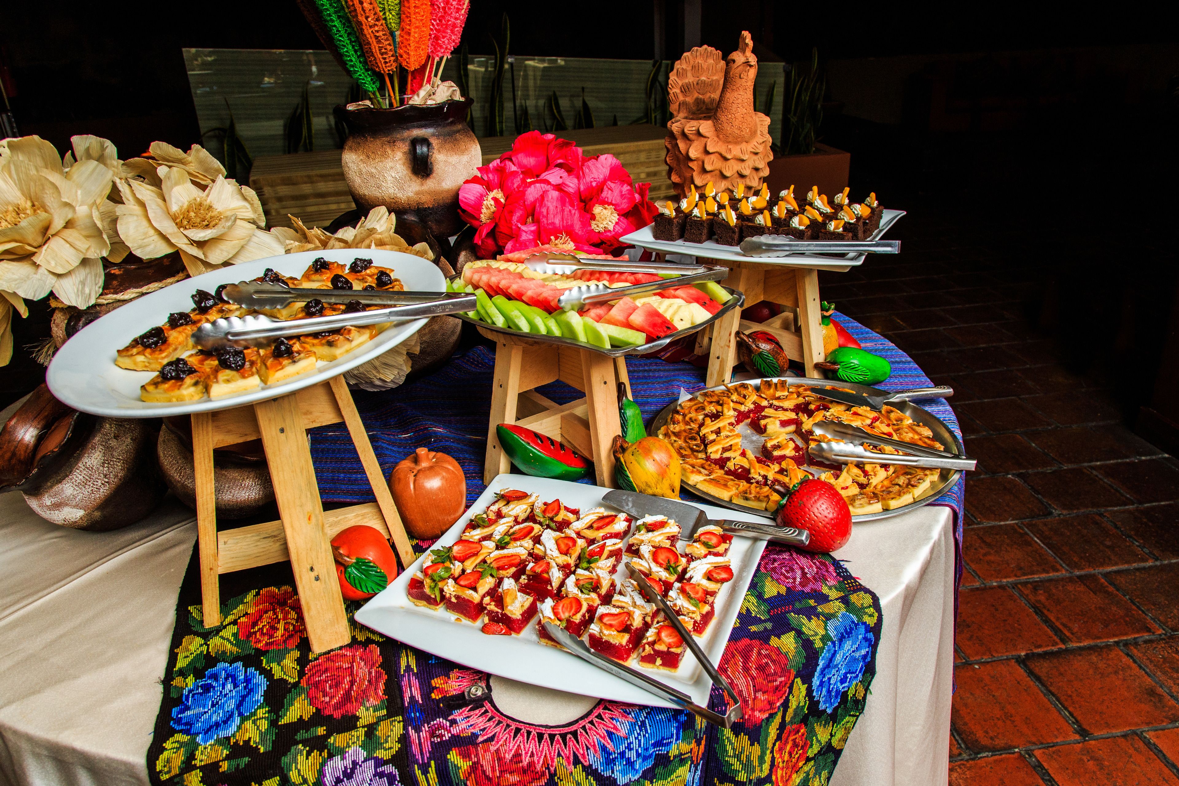 A buffet table with various dishes and a decorative centerpiece.