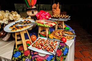 A buffet table with various dishes and a decorative centerpiece.