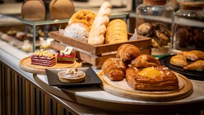 A variety of pastries and desserts displayed on a counter. - Hilton Mandalay (Mandalay)