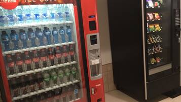 A vending machine with multiple beverage options, including water and soda.