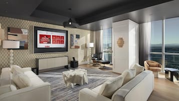 Una sala de estar moderna con un televisor grande, asientos cómodos, vistas a la ciudad y un papel tapiz estampado.