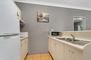 Family Apartment | Private kitchen | Microwave, coffee/tea maker, electric kettle, cookware/dishes/utensils