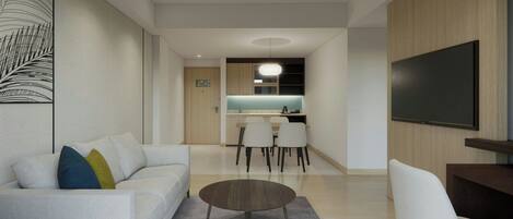 A modern living room with a sofa, coffee table, and a flat-screen TV.