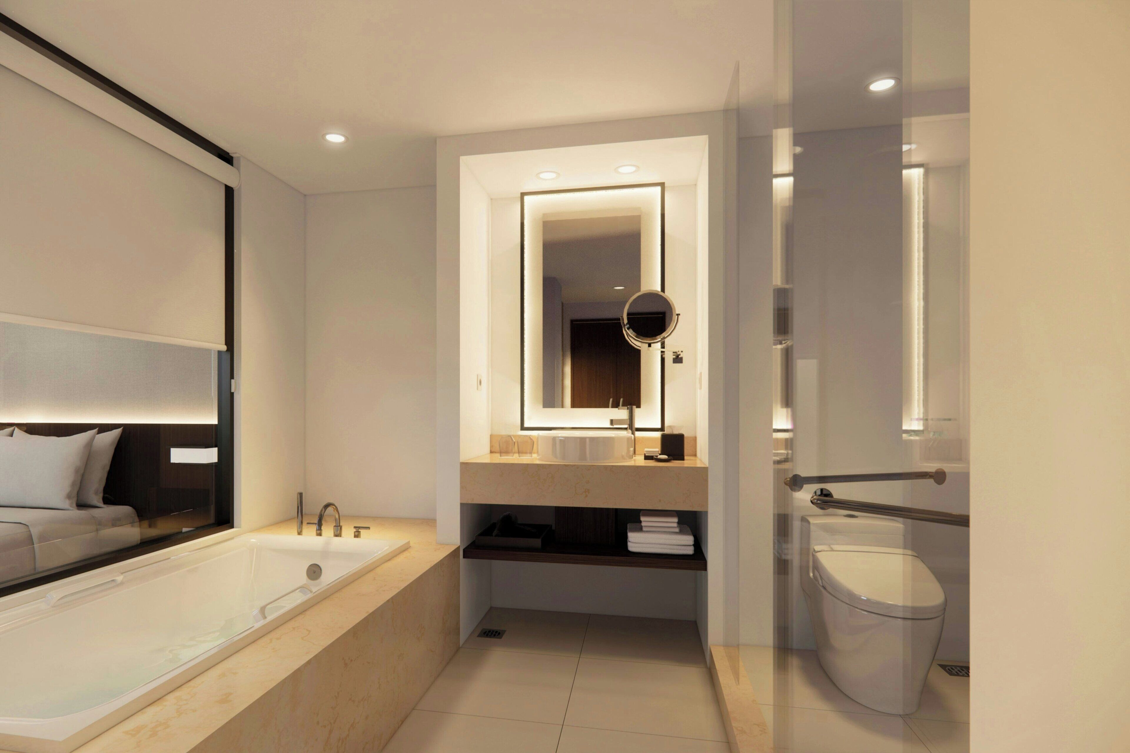 A modern bathroom with a bathtub, a sink with a mirror, and a toilet.