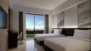 A modern hotel room with two beds, a desk, and a large window offering a view of the outdoors. - Courtyard by Marriott Manado (Manado)
